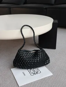 Black woven leather shoulder bag, retro hobo style minimalist design for daily fashion.
