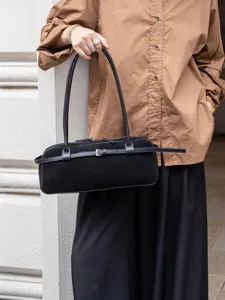 Black suede shoulder bag for women, retro baguette bag with stylish belt buckle detail.