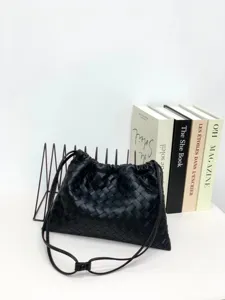Black woven leather shoulder bag, chic slouchy crossbody pouch with drawstring closure.