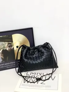Detailed view of the black woven leather drawstring shoulder bag, featuring classic intrecciato design.