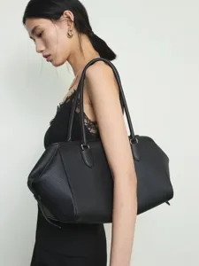 Minimalist top layer cowhide bowling shoulder bag, elegant black large capacity commuting tote.