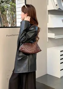 Detail shot of the retro woven leather shoulder bag in dark brown, showing stylish texture.