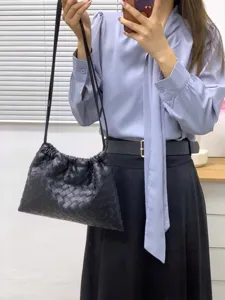 Black woven leather shoulder bag stylish slouchy bucket handbag for daily casual wear.