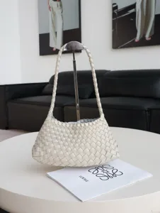 Detailed view of the woven leather shoulder bag in light beige, showing exquisite craftsmanship.