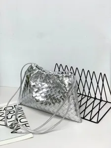 Detail shot of silver woven leather pouch bag showing intrecciato texture and drawstring closure.