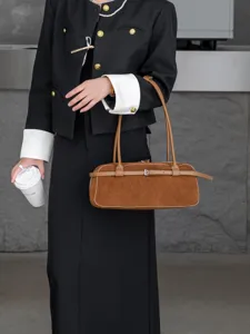 Retro brown suede baguette bag for women, stylish vintage shoulder tote with adjustable strap.
