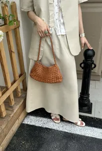 Handcrafted brown woven leather shoulder bag detail, stylish fashion accessory for daily wear.