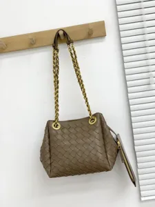 Vue détaillée du sac porté épaule en cuir tressé marron avec bandoulière chaîne et pochette.