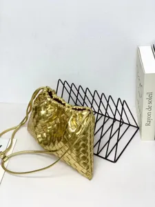 Gold woven leather shoulder bag, stylish intrecciato pouch design with drawstring closure.