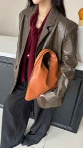 Sac à main triangulaire en cuir véritable, élégant sac marron pour femme et mode.