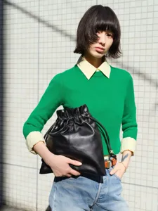 Black leather drawstring bucket bag for women, large capacity soft cloud shoulder handbag.