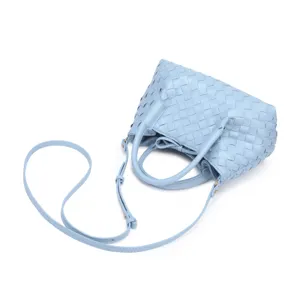 Light blue woven leather tote bag with dual handles and adjustable strap for women fashion