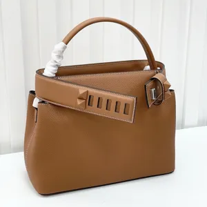 Brown leather top handle handbag with pyramid studs elegant shoulder crossbody bag detail
