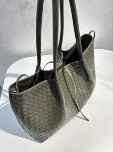 Olive green leather woven tote bag detail showing premium texture and large capacity design.