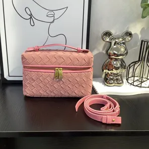 Pink suede woven vanity shoulder bag for women, stylish crossbody square bag with strap.