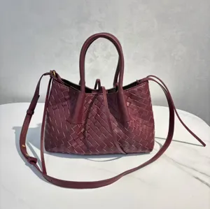 Burgundy leather woven tote bag with top handles and shoulder strap, large capacity daily use.