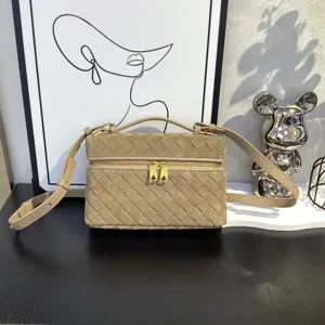 Detail view of a stylish khaki suede woven crossbody box bag with dual zippers and adjustable strap.