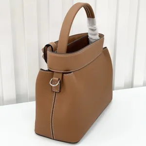 Brown leather top handle bag, premium cowhide retro shoulder crossbody bag detail view.