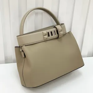 Classic leather top handle handbag with pyramid stud hardware and elegant vintage retro design.