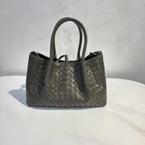Woven leather tote bag detailed view, large capacity dark green handbag for daily use.