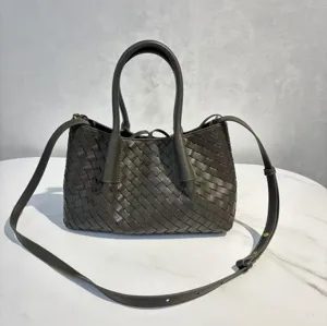 Dark grey woven leather tote bag with top handles and adjustable shoulder strap for daily use.