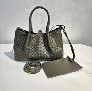 Dark green woven leather tote bag detail, large capacity luxury shoulder handbag with strap.