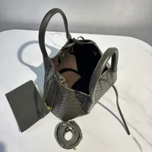 Stylish leather woven handbag with comfortable shoulder strap and spacious tote design for daily use.
