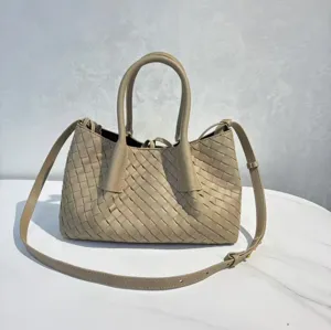 Detailed view of the woven leather tote bag, showcasing intricate intrecciato weave and handle.