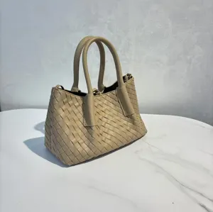 Detailed view of beige leather woven handbag, elegant shoulder tote bag for daily chic style.
