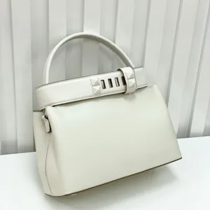 Premium white leather top handle handbag with chic pyramid stud strap design elegant retro style.