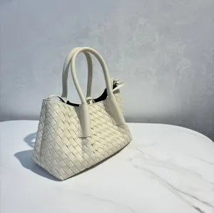 Cream white woven leather handbag detail, classic intrecciato design tote bag for women.