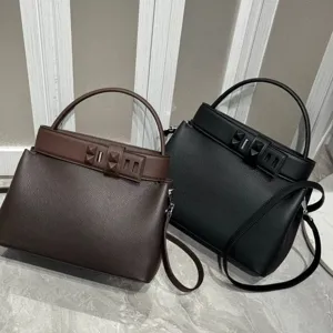 Luxury leather top-handle crossbody bag with statement pyramid stud lock design for women