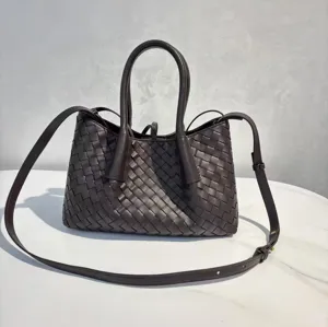 Dark brown woven leather tote bag with top handles and adjustable shoulder strap for women.