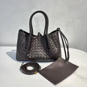 Genuine leather woven tote bag with top handles, detachable strap, and matching pouch.