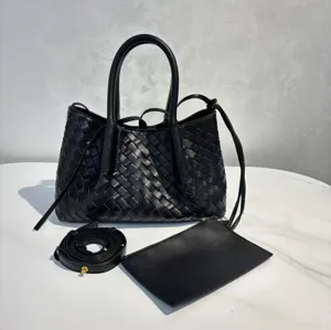 Black leather woven tote bag with double handles, detachable shoulder strap and matching pouch.