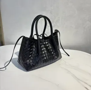 Black genuine leather woven tote bag with top handles and shoulder strap for women