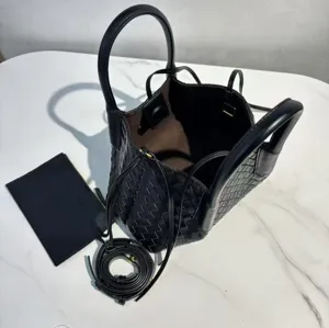 Black genuine leather woven tote bag with top handles, long strap and matching pouch.