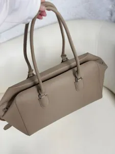 Minimalist leather EW bowling tote bag detail, premium taupe shoulder bag for women daily commute.