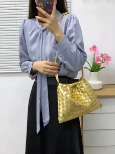 Gold woven leather pouch bag detail, showing exquisite intrecciato craftsmanship and stylish style.