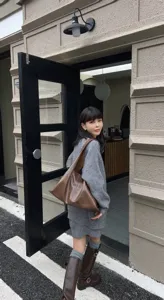 Detailed view of soft leather hobo shoulder bag in daily lifestyle scene, casual style.