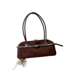 Brown suede baguette shoulder bag for women with elegant leather strap and retro design.