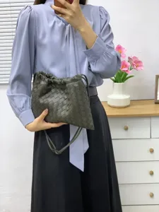 Dark green woven leather pouch bag, stylish casual crossbody drawstring bag for women.