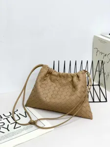 Woven leather shoulder bag for women, casual crossbody pouch bag with convenient drawstring.