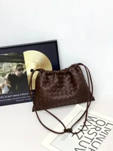 Dark brown woven leather shoulder bag, elegant casual crossbody pouch with secure drawstring.