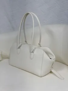 Minimalist white genuine leather EW bowling bag, large capacity commuter shoulder tote.
