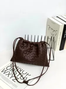 Woven leather crossbody pouch bag detail, stylish brown shoulder drawstring cloud handbag.