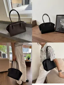 Minimalist leather tote bag with dual handles, spacious interior for daily commute and use.