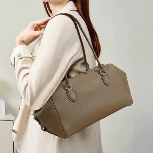 Minimalist genuine leather bowling shoulder bag for women, large capacity daily commuter tote.