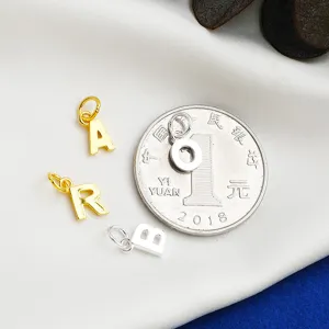 Detailed macro view of mini S925 sterling silver alphabet charms for DIY jewelry making