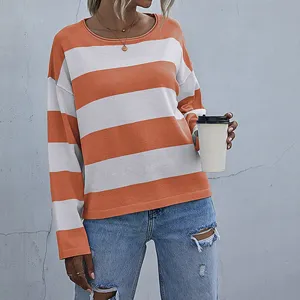 Detail of a casual orange and white striped round neck knit sweater for women.